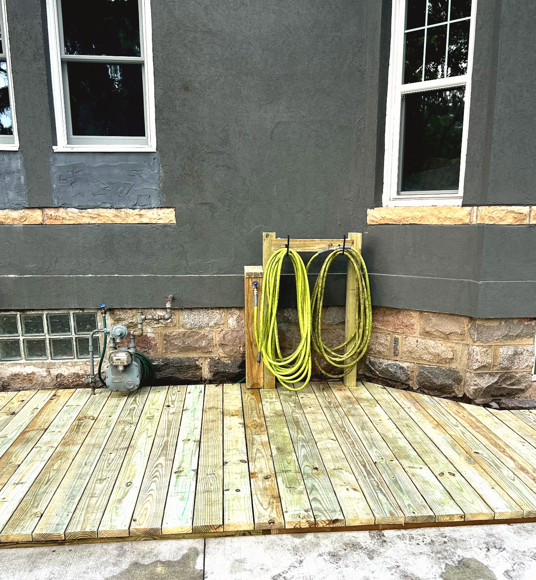 Detail view of pressure-treated deck boards and stone foundation work
